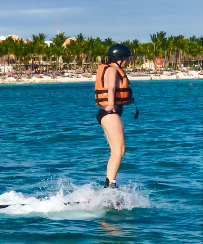 What is flyboarding? A review featured by top family travel blog, More Than Main Street: image of a woman flyboarding for the first time.