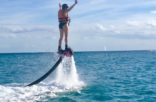 What is flyboarding? A review featured by top family travel blog, More Than Main Street: image of a woman flyboarding for the first time.