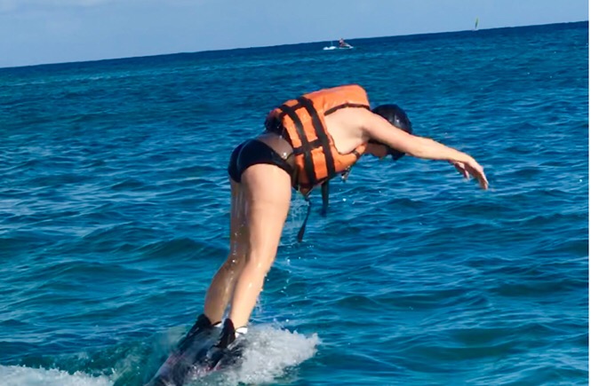 What is flyboarding? A review featured by top family travel blog, More Than Main Street: image of a woman flyboarding for the first time.