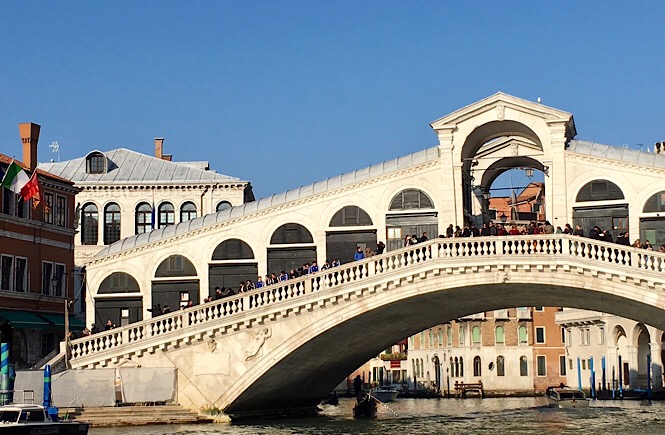 Crowds of tourists on the Rialto Bridge Venice Italy