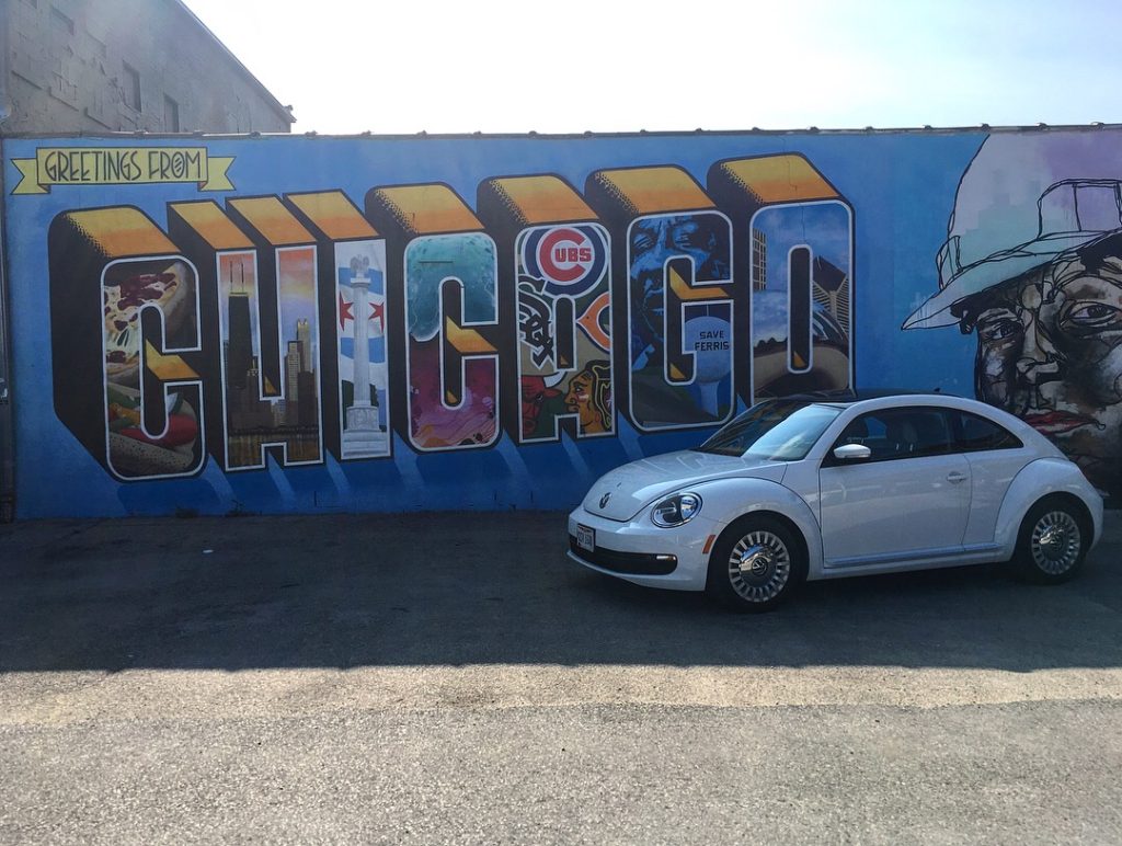 Top Things to Do in the Midwest: 4 Best Midwest Road Trip Ideas featured by top US family travel blog, More than Main Street: the Chicago sign with a Volkswagen Bug.