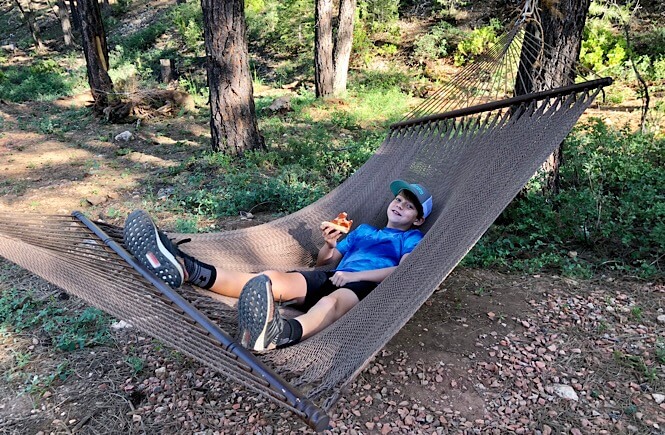 Bryce Canyon Glamping experience featured by top US family travel blog, More Than Main Street: image of 
 Dinner in the hammock...not too shabby!