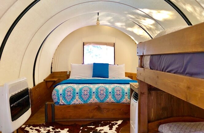 Bryce Canyon Glamping experience featured by top US family travel blog, More Than Main Street: image of 
 conestoga wagons glamping utah