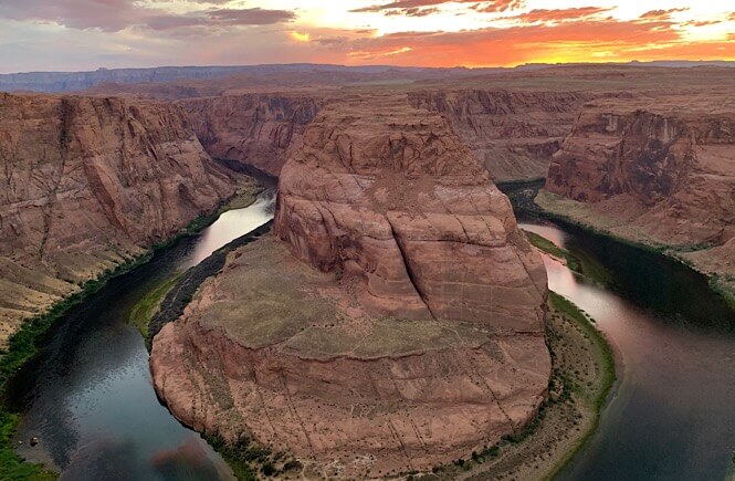 Top US family travel blog, More than Main Street, shares the ultimate 2 week Utah Arizona road trip itinerary; Horseshoe Bend in Page Arizona at sunset.