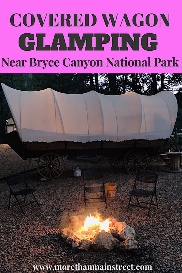 Bryce Canyon Glamping experience featured by top US family travel blog, More Than Main Street: image of 
 Glamping in a covered wagon at night by the fire in Utah.