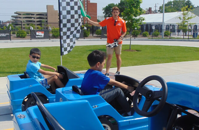 Top 15 best unique spring break vacations in the US for families featured by US family travel blog, More Than Main Street: racetrack in Indianapolis, Indiana.