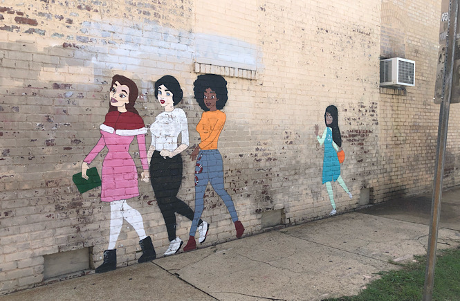 Top 10 Raleigh NC Murals to Visit with your Family featured by top US travel blog More than Main Street: girl power mural.