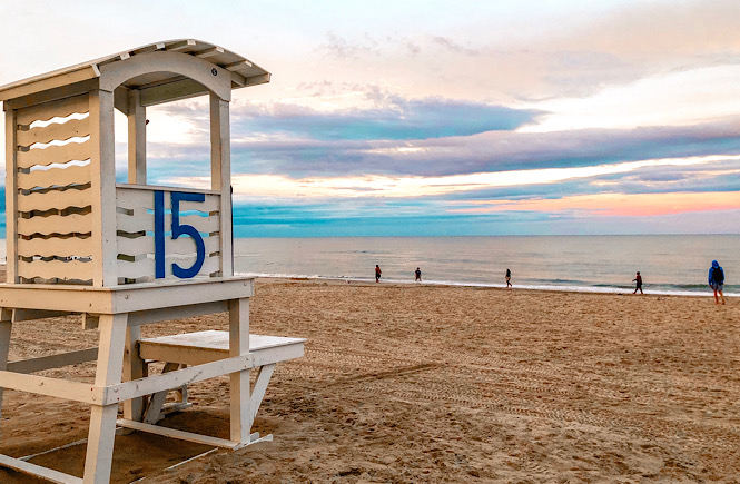 Top 10 fun things to do in Carolina Beach NC featured by top US travel blog, More than Main Street: beach and lifeguard stand.