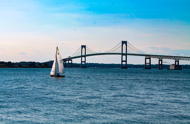 Newport Rhode Island bridge and sailboat- the perfect east coast destination for families.