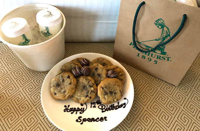 Top 10 Best Things to Do in Pinehurst NC featured by top US travel blog, More than Main Street: image of cookies, milk, and birthday gift from the Pinehurst Resort at the Carolina Hotel.