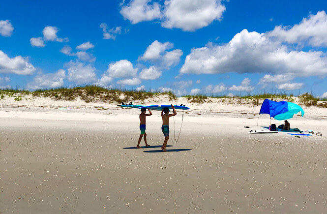 boys surfing on Masonboro Island in NC.