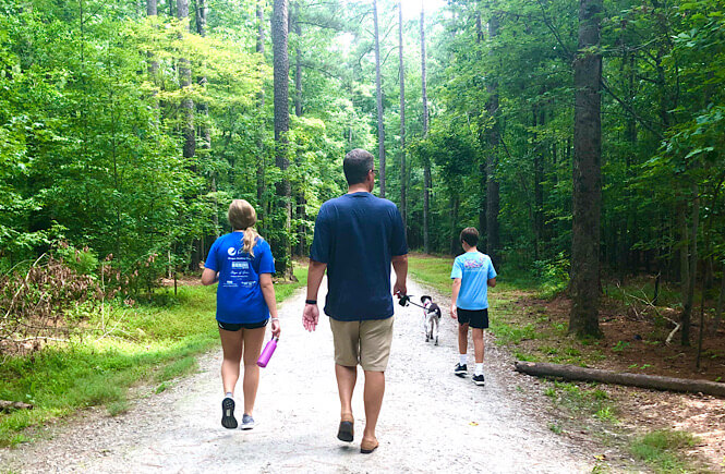 Family going on a nature walk to practice mindfulness together.