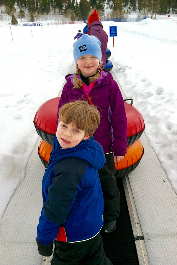 Two kids getting ready to go snow tubing!! Add this to your winter bucket list!