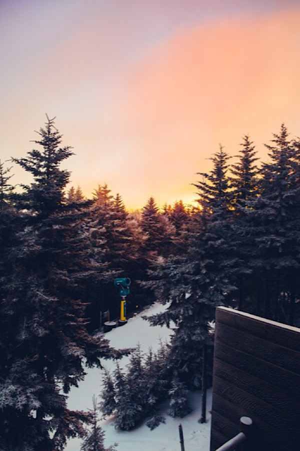 A magical sunrise over snow covered trees in Snowshoe Mountain West Virginia.