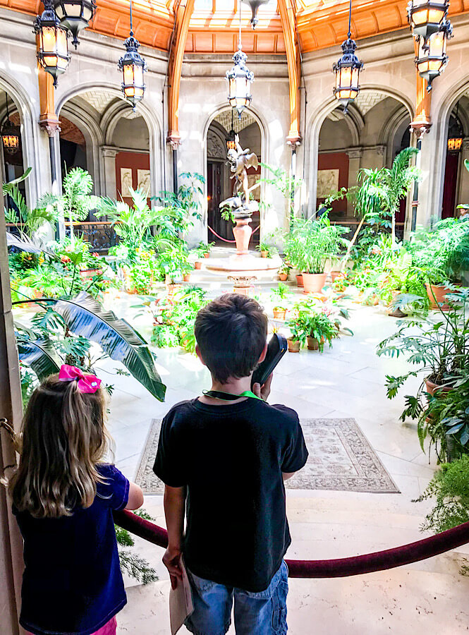 A girl and a boy listen to the audio tour at The Biltmore Estate in Asheville NC.