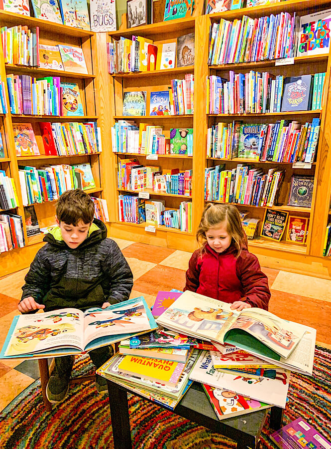A boy and a girl enjoying kid friendly Malaprop's Bookstore in Asheville North Carolina.