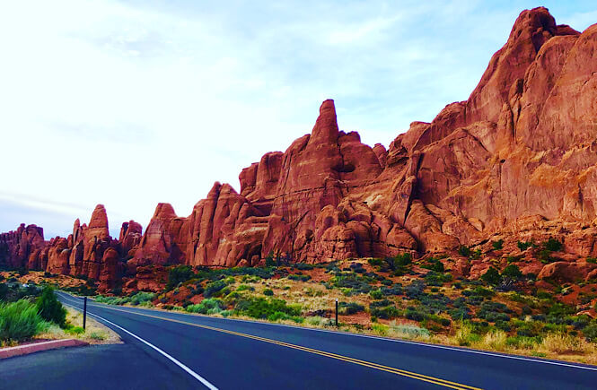 20 Best USA road trip ideas and destinations featured by top US family travel blog, More than Main Street. Image of the road in Arches National Park in Moab Utah.