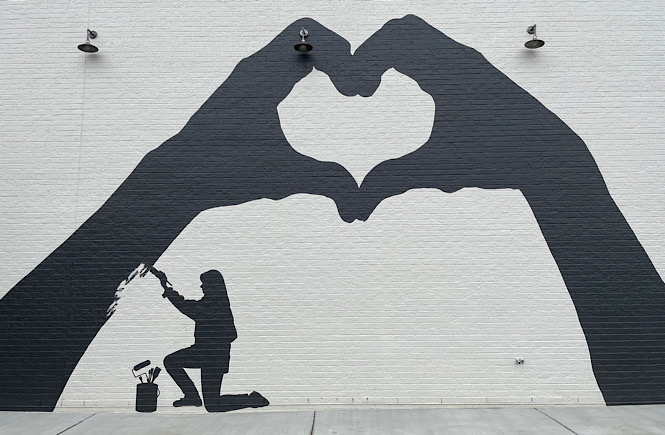 Heart hands mural by Crumbl cookies in Raleigh NC.