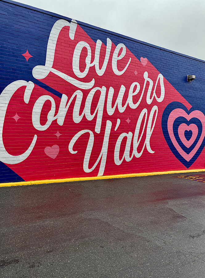 Love Conquers Y'all wall mural at Cameron Village in Raleigh NC.