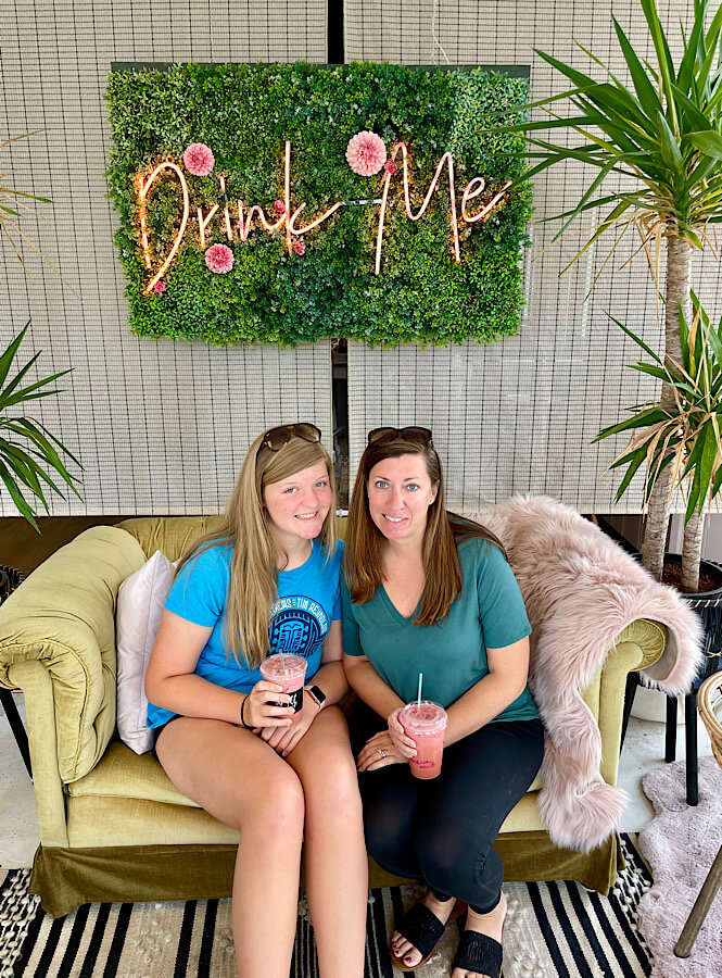 The super insta-worthy spot at Spill coffee shop has a couch with a sign over it that says "Drink Me".