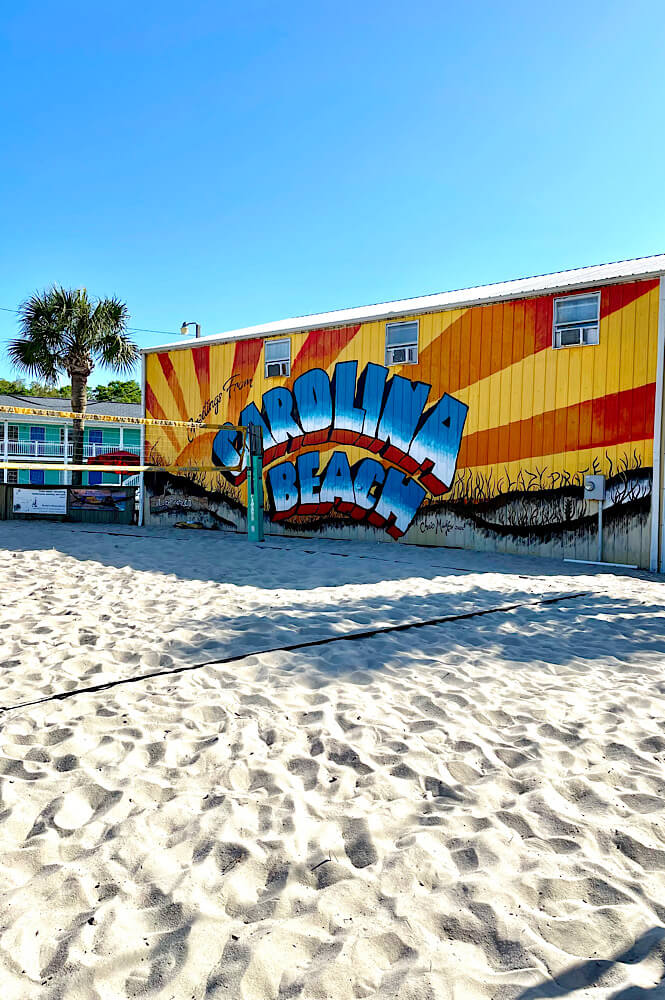 beach volleyball net at the Lazy Pirate with a Carolina Beach mural in the background.