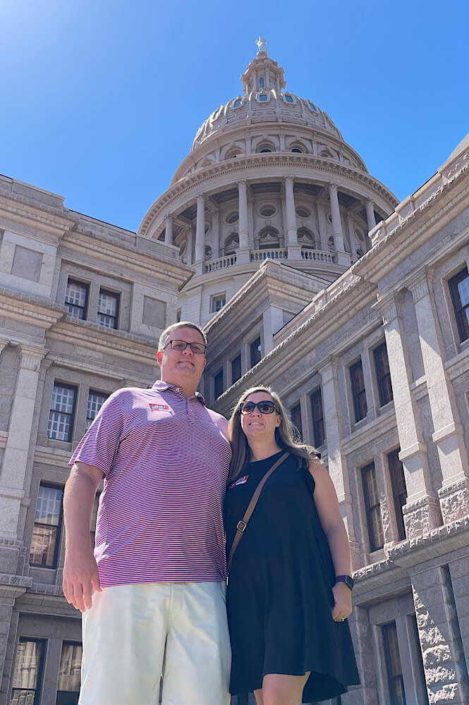 Couple in front of the state capitol in Austin Texas