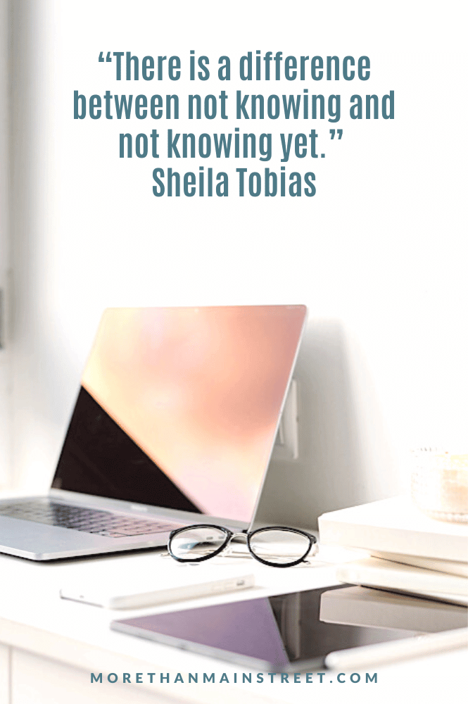 mindset quote about the power of yet by sheila tobias. image of a desk with a laptop, glasses and tablet