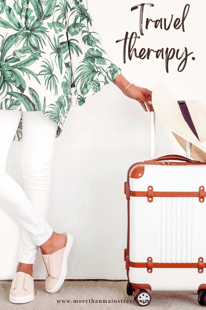 Travel therapy- vacation captions for Instagram (image of a women standing with a sun hat and suitcase)