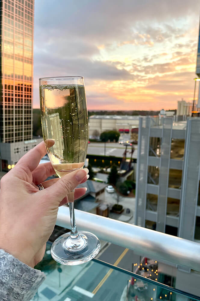 Sunset with a glass of champagne at a Raleigh rooftop bar