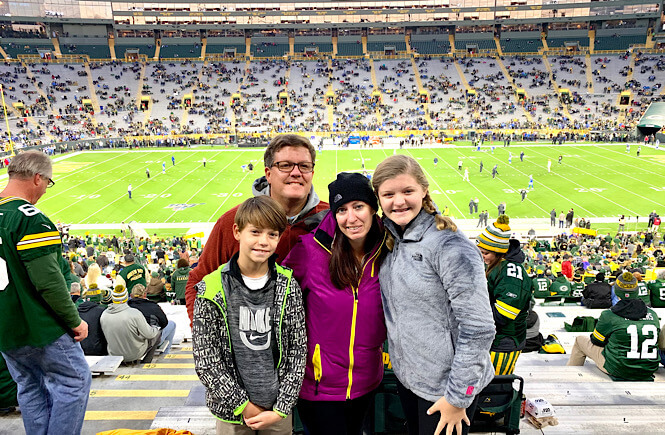 family at a Green Bay Packers game in Green Bay Wisconsin- one of the best weekend trips from Chicago for any sports enthusiast