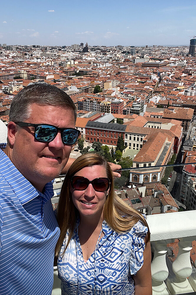 couple smiling on a rooftop in a big city