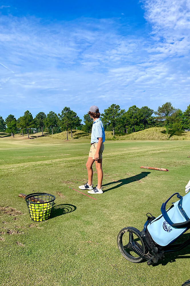 best golf instagram captions (image of teen boy on the driving range)