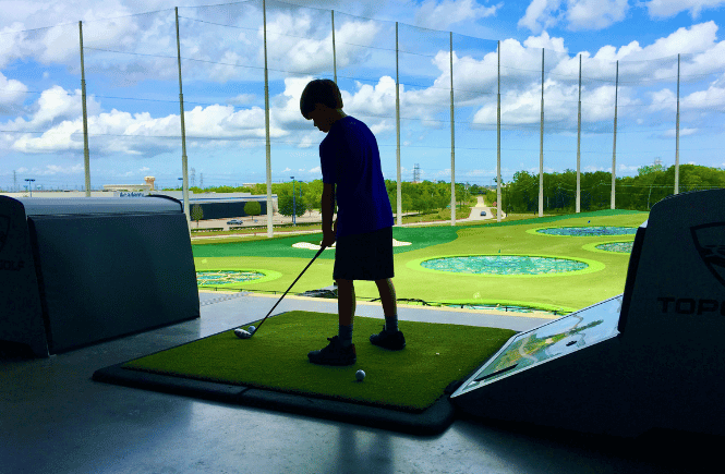 boy playing Topgolf