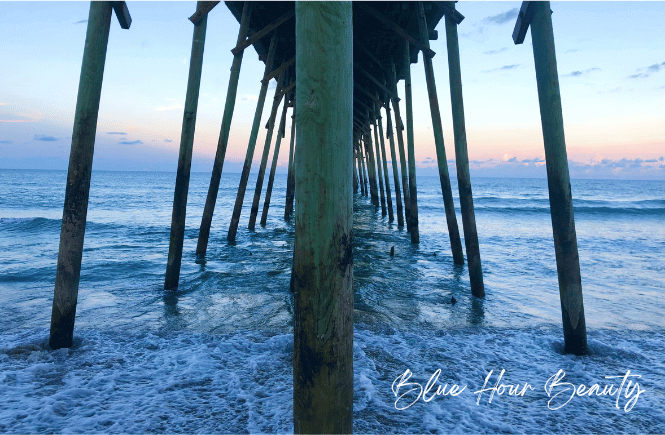 Blue hour caption: image of ocean pier at sunset with various shades of blue sky
