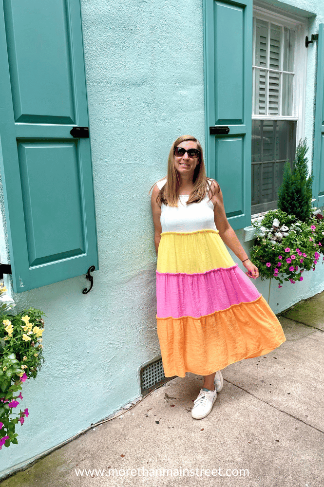 Charleston Instagram spots- photo of woman in front of teal colored house on Rainbow row 