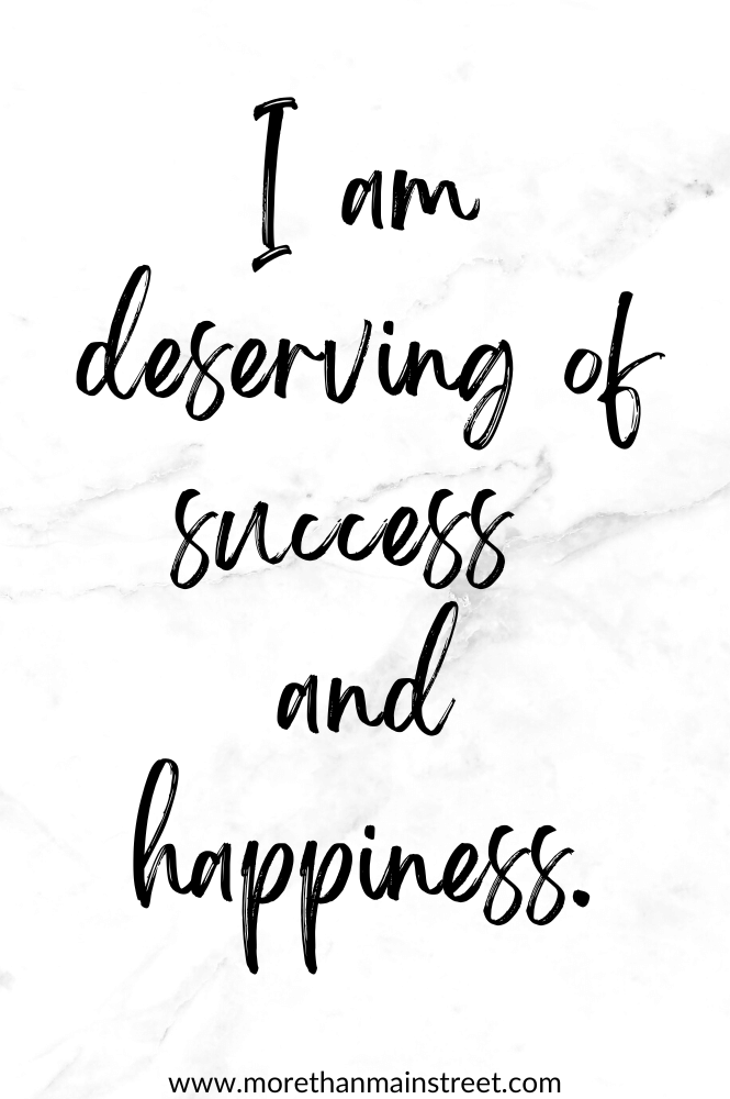 White marbled background with happiness affirmation: I am deserving of success and happiness.