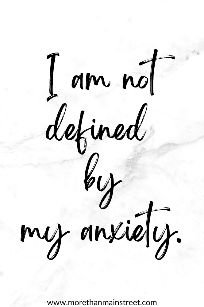 White marbled background with an affirmation for anxiety: I am not defined by my anxiety.