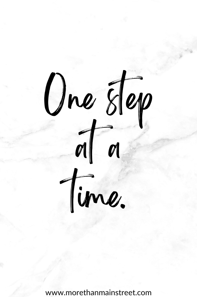 White/ black marble background with words "one step at a time" to use as a daily morning affirmation