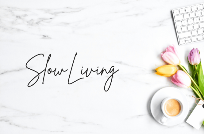 slow living (image of white marble background with a cup of coffee, tulips and keyboard flatlay)