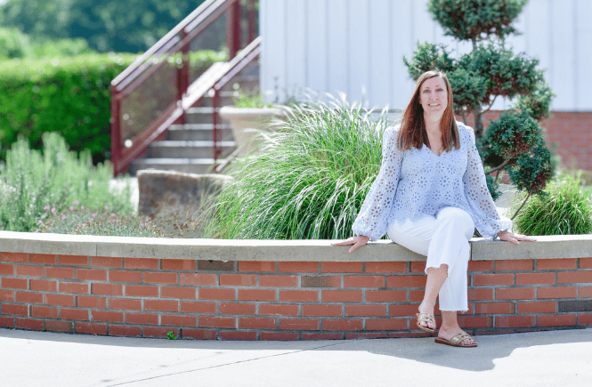 Julie Thorne sitting on a brick wall