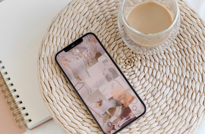Iphone and a cup of coffee on a wicker table as a symbol of intentionally putting your phone down for a mindful moment