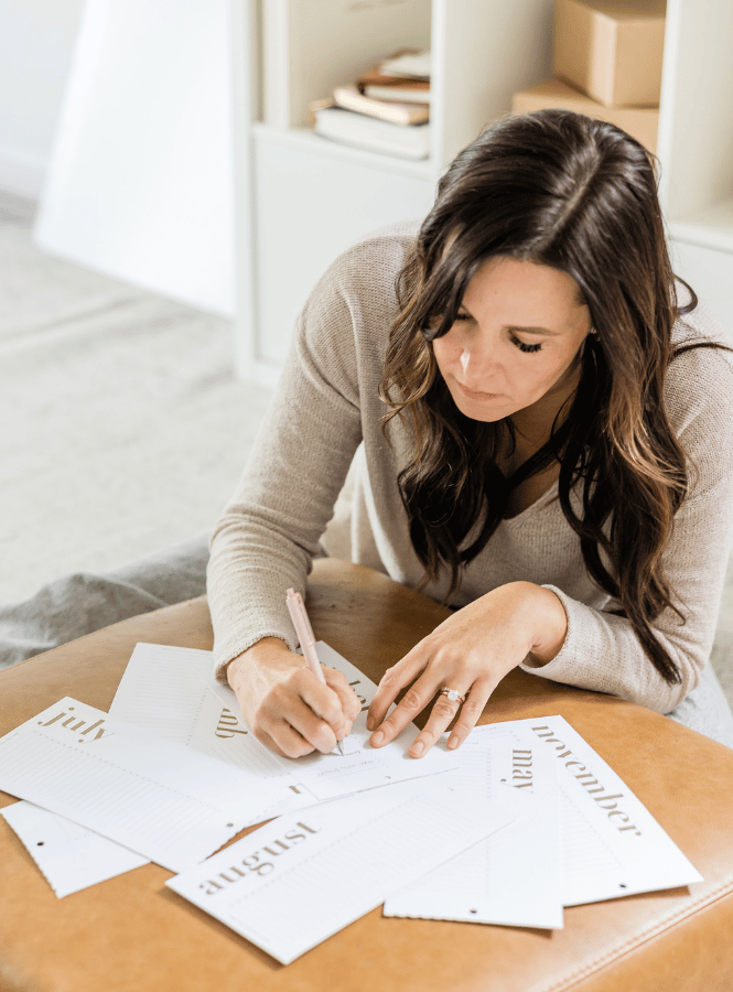 Writing physical lists is a simple way to start going analog. (woman writing a list.)